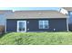 Backyard showing the house's back side with a sliding door, a window, and a grassy yard at 944 Redwood Dr, Franklin, IN 46131