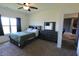 Comfortable bedroom boasts window, ceiling fan, dresser, and comfortable queen bed at 944 Redwood Dr, Franklin, IN 46131