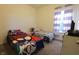 Bedroom displays two beds with playful character themes and a window dressed in purple and white striped curtains at 944 Redwood Dr, Franklin, IN 46131