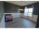 A well lit dining room with a large window, simple light fixture and plank floors at 944 Redwood Dr, Franklin, IN 46131