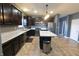 Open concept kitchen with an island, stainless steel appliances, and dark cabinetry at 944 Redwood Dr, Franklin, IN 46131