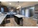 Open concept kitchen featuring a center island, dark cabinets, stainless appliances and laminate floors at 944 Redwood Dr, Franklin, IN 46131