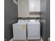 Laundry room offers a front-load washer and dryer set against gray walls and a brick-patterned accent wall at 944 Redwood Dr, Franklin, IN 46131