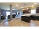 Open living room features dark cabinetry, light countertops and transitions to carpeted living space at 944 Redwood Dr, Franklin, IN 46131