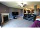 Open living area with television, fireplace and electric sofa with view of kitchen at 944 Redwood Dr, Franklin, IN 46131