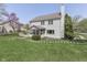 Well-maintained backyard featuring a screened porch, deck, and lush green lawn, ideal for outdoor relaxation at 9760 Logan Ln, Fishers, IN 46037