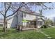 Spacious backyard with a deck, screened porch, and manicured lawn, perfect for enjoying the outdoors at 9760 Logan Ln, Fishers, IN 46037