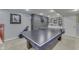 Finished basement featuring a ping pong table with stylish black wood accent wall and shelving for games and entertainment at 9760 Logan Ln, Fishers, IN 46037