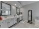 Bathroom featuring a double vanity with a full mirror and ample lighting at 9760 Logan Ln, Fishers, IN 46037