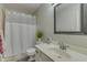 Standard bathroom featuring a toilet, sink, mirror, and shower with a white shower curtain at 9760 Logan Ln, Fishers, IN 46037
