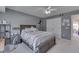 Neutral bedroom with a modern bed frame, ceiling fan, and closet with paneled doors at 9760 Logan Ln, Fishers, IN 46037