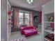 Pink and grey bedroom features a pink sofa, curtains, and unique wall decals at 9760 Logan Ln, Fishers, IN 46037