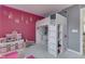 Bedroom with a lofted bed, adjacent shelving, and pink wall decor at 9760 Logan Ln, Fishers, IN 46037