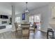 Stylish dining area with modern chandelier, flowing to the patio and living area at 9760 Logan Ln, Fishers, IN 46037