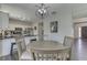 Bright dining area featuring modern lighting and a seamless transition to the adjacent kitchen at 9760 Logan Ln, Fishers, IN 46037
