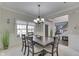 Inviting dining room featuring a modern chandelier and entry view at 9760 Logan Ln, Fishers, IN 46037