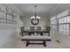 Elegant dining room with a wooden table, bench seating, and a modern chandelier at 9760 Logan Ln, Fishers, IN 46037