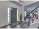 Welcoming entryway with hardwood floors, a staircase, and views into the living room at 9760 Logan Ln, Fishers, IN 46037