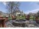 Inviting outdoor fire pit area with Adirondack chairs and a spacious backyard, perfect for entertaining guests at 9760 Logan Ln, Fishers, IN 46037