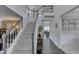 Spacious foyer with hardwood floors, staircase, and views into the dining area at 9760 Logan Ln, Fishers, IN 46037