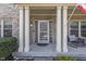 Inviting front porch with classic columns, cozy seating, and a welcoming atmosphere at 9760 Logan Ln, Fishers, IN 46037