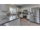 Modern kitchen features stainless steel appliances, granite countertops and white subway tile backsplash at 9760 Logan Ln, Fishers, IN 46037