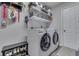 Functional laundry room featuring modern washer and dryer, organized shelving, and extra storage at 9760 Logan Ln, Fishers, IN 46037
