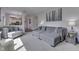 Open living room features a stylish gray sectional and hardwood floors at 9760 Logan Ln, Fishers, IN 46037