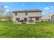 Spacious backyard boasts a fire pit, ample seating, and a well-manicured lawn at 1014 Sugar Maple Dr, Greenwood, IN 46143