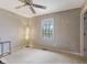 This bedroom has a ceiling fan, a large window, and neutral carpeting at 1014 Sugar Maple Dr, Greenwood, IN 46143