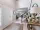 Bright foyer features tile floors, a staircase with white railings, and an inviting view to the living area at 1014 Sugar Maple Dr, Greenwood, IN 46143