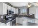Updated kitchen featuring stainless steel appliances, dark countertops, and stylish tile backsplash at 1014 Sugar Maple Dr, Greenwood, IN 46143