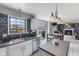 Modern kitchen with white cabinetry, stainless appliances, and an eat-in area overlooking backyard at 1014 Sugar Maple Dr, Greenwood, IN 46143