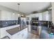 Well-lit kitchen features white cabinets, stainless steel appliances, and a functional center island at 1014 Sugar Maple Dr, Greenwood, IN 46143