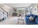 Inviting living room with large window, blue sofa, and cozy decor. View of stairway and entry at 1014 Sugar Maple Dr, Greenwood, IN 46143
