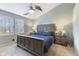 Relaxing bedroom with vaulted ceiling, ceiling fan, and large window with a view of the greenery outside at 1014 Sugar Maple Dr, Greenwood, IN 46143