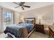 This main bedroom is well-lit, with a beautiful bed, side tables, and large window at 1014 Sugar Maple Dr, Greenwood, IN 46143