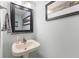 Cozy powder room features a pedestal sink, framed mirror, and tasteful decor at 1014 Sugar Maple Dr, Greenwood, IN 46143