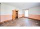 Empty bedroom featuring original hardwood floors, light colored walls and a large window at 10723 E State Road 234, Wilkinson, IN 46186