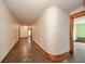 This hallway features wood floors, wallpaper, and dark wood trim at 10723 E State Road 234, Wilkinson, IN 46186