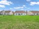 Expansive backyard with lush lawn and a view of the home's rear exterior at 10844 Tedder Lake Dr, Indianapolis, IN 46239
