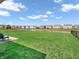 Spacious backyard with green grass, a pond, and a view of neighboring homes at 10844 Tedder Lake Dr, Indianapolis, IN 46239