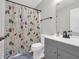 Charming bathroom featuring a vanity, toilet, and shower with a decorative curtain at 10844 Tedder Lake Dr, Indianapolis, IN 46239