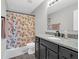 Updated bathroom with granite countertop, modern vanity, and shower-tub combination with decorative curtain at 10844 Tedder Lake Dr, Indianapolis, IN 46239