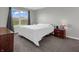 Cozy bedroom with plush carpeting and a large window for natural light at 10844 Tedder Lake Dr, Indianapolis, IN 46239