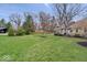 Expansive backyard showcasing a lush lawn, mature trees, and the home's exterior, perfect for outdoor enjoyment at 1234 E 71St St, Indianapolis, IN 46220
