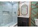 Upgraded bathroom with tile shower, sleek vanity, and decorative mirror at 1234 E 71St St, Indianapolis, IN 46220