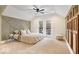 Spacious primary bedroom with neutral tones, ample natural light, and a ceiling fan at 1234 E 71St St, Indianapolis, IN 46220