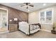 Comfortable bedroom boasts decorative accent wall, ceiling fan, and natural light at 1234 E 71St St, Indianapolis, IN 46220