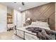 Bedroom features decorative accent wall, ceiling fan, and custom shelving at 1234 E 71St St, Indianapolis, IN 46220